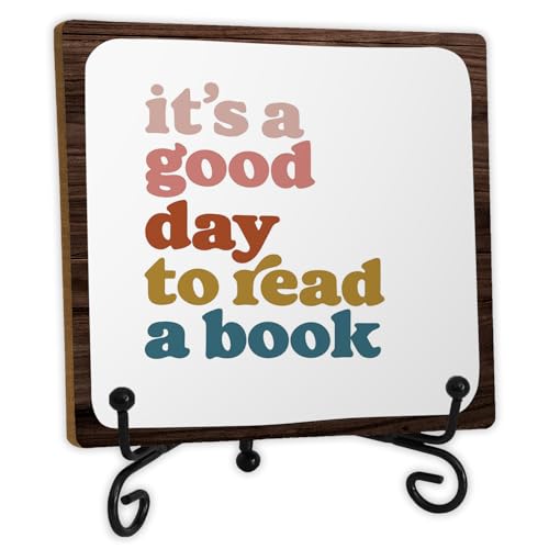 A small wooden desk sign reading it's a good day to read a book, on a metal stand