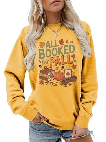Mustard yellow sweatshirt printed with books and pumpkins under the phrase All Booked for Fall