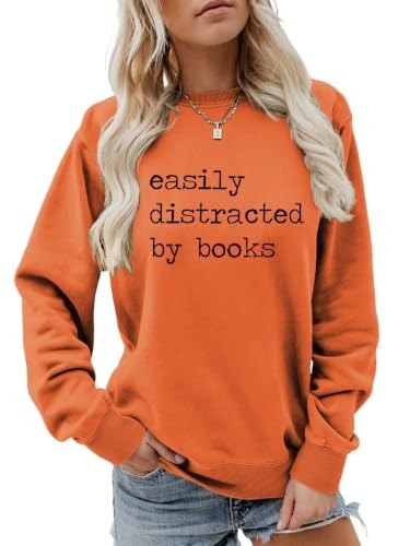Pumpkin orange sweatshirt with the phrase Easily Distracted by Books in lowercase script