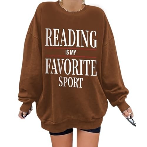 Brown oversized sweatshirt with the phrase Reading Is My Favorite Sport in bold cream lettering
