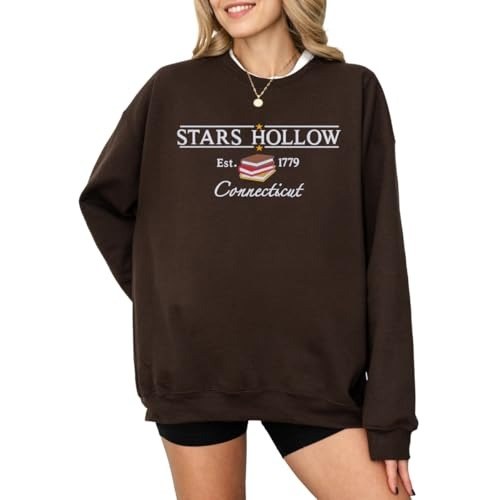 Dark brown crewneck with a small embroidered town name and est. date across the chest