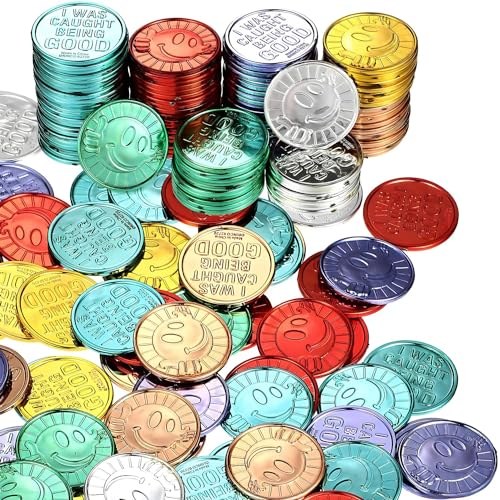 Gold plastic tokens stamped Caught Being Good in a bulk pile