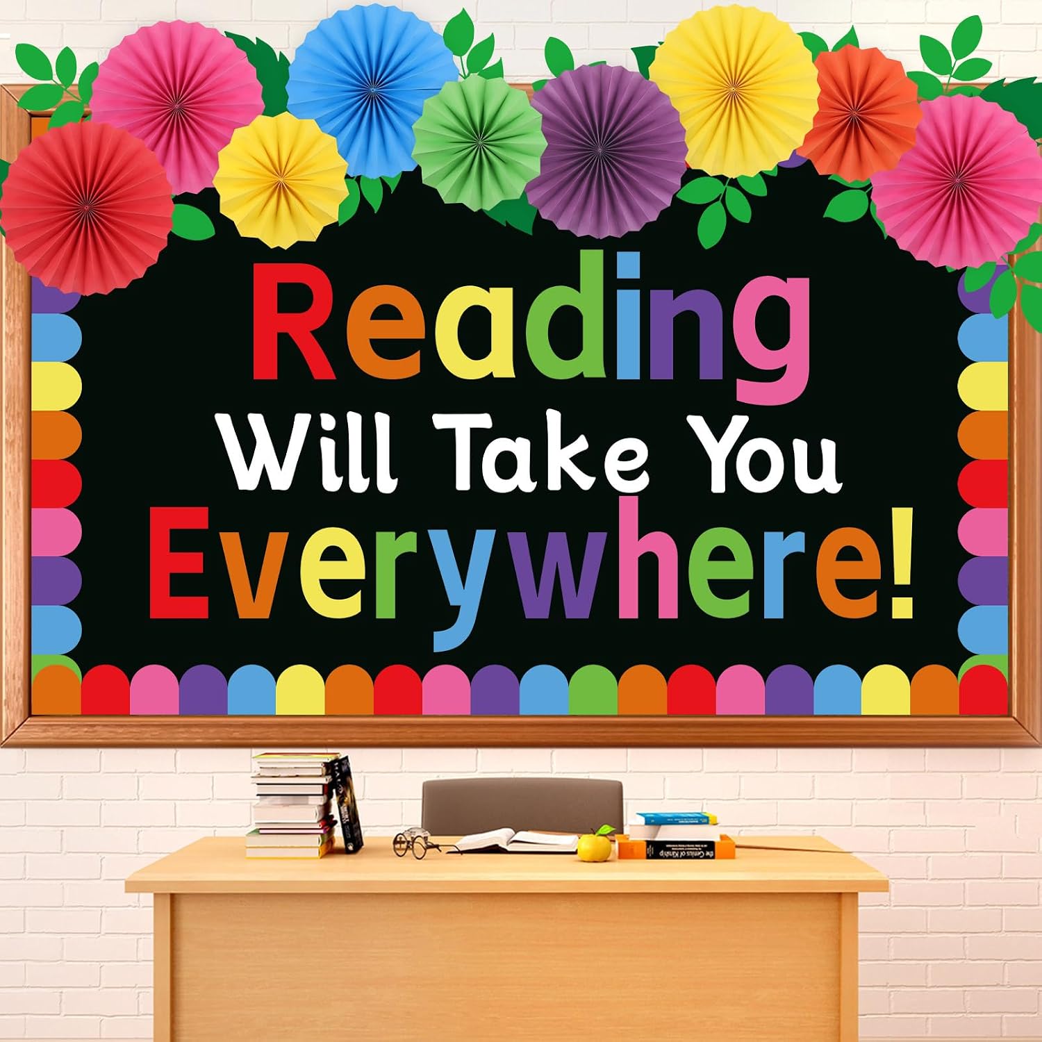 Colorful paper rosette fans and tassels above bold lettering on a black board