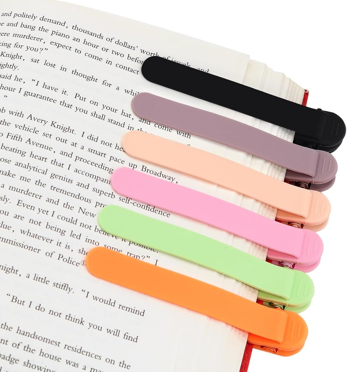 Silicone clip bookmarks in six colors clipped along the edge of a page