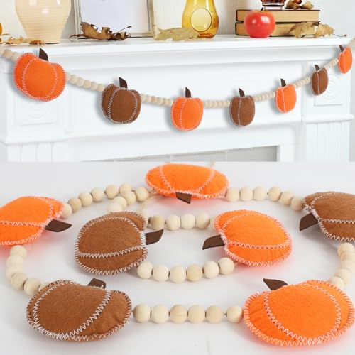 Felt pumpkin garland in orange and brown strung between cream wooden beads along a mantel