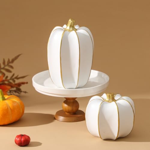 Pair of smooth white resin pumpkins banded in gold, one on a small pedestal stand
