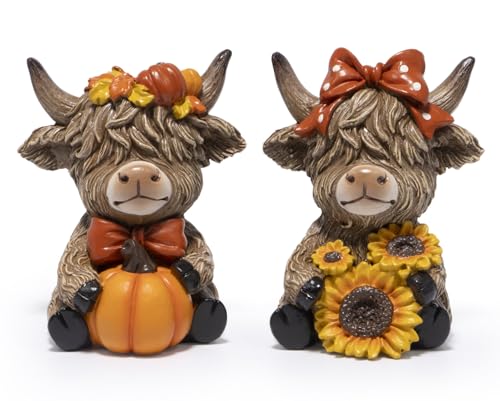 Two small resin highland cow figurines, one holding a pumpkin and one with sunflowers