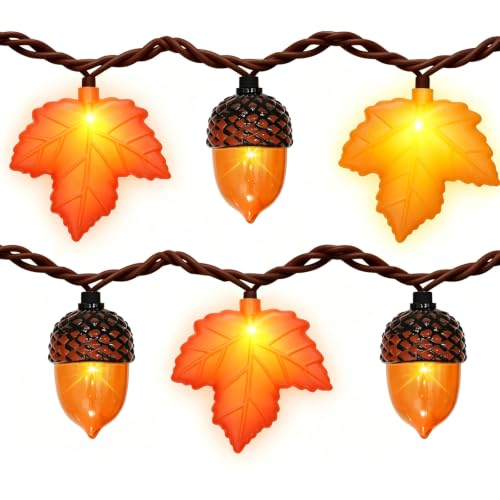 String lights with molded maple leaf and acorn bulbs glowing orange and amber on a brown wire