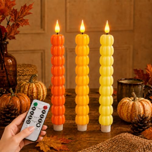 Three stacked pumpkin taper candles in orange and gold with flickering LED flames and a remote