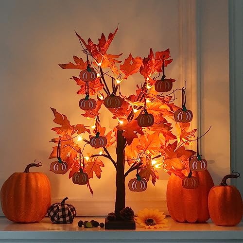 Small lighted tabletop maple tree with warm LEDs and little wooden pumpkin ornaments hanging from the branches