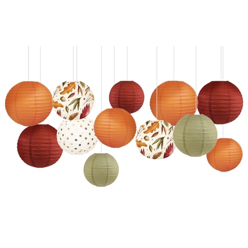 Hanging paper lanterns in burgundy, rust, sage and cream, several printed with autumn leaves
