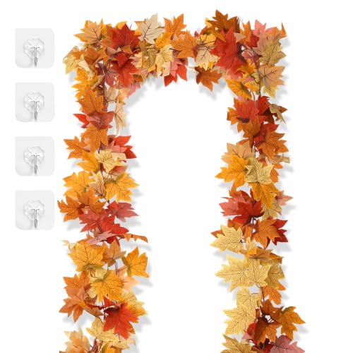 Long artificial maple leaf vines in orange, gold and red arched around a doorway with adhesive hooks