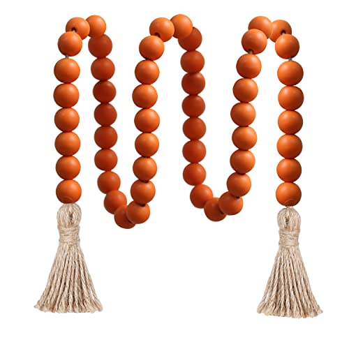 Chunky rust orange wooden bead garland finished with natural jute tassels at each end