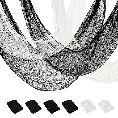 Lengths of tattered black and white gauze cloth with frayed open weave