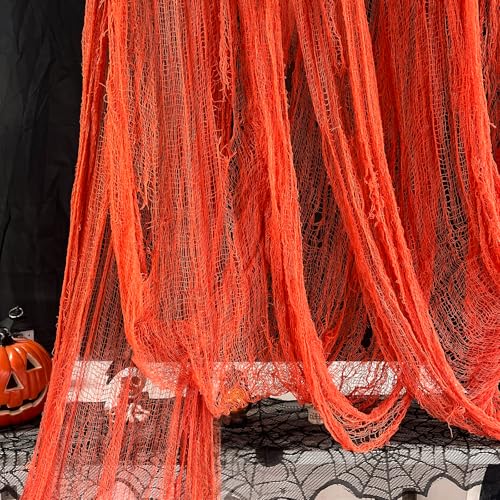 A long bolt of orange gauze cloth with a loose tattered weave