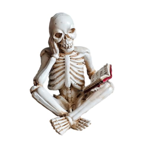 Small gray skeleton figurines posed sitting and reading books