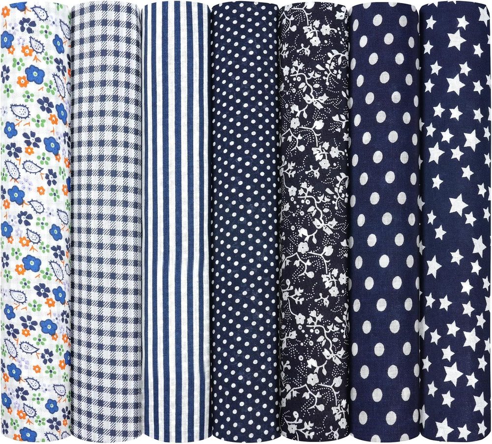 Seven folded cotton fabric squares in assorted dark blue patterns