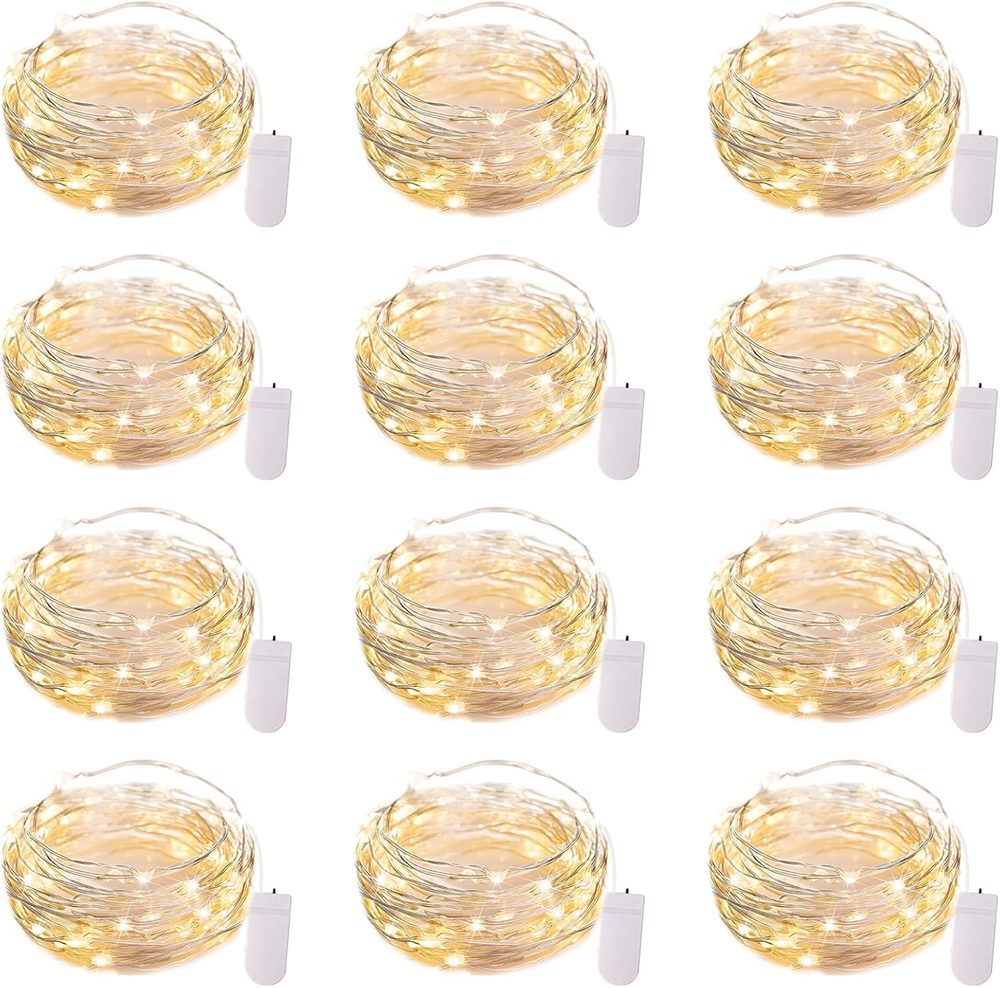 Twelve coiled silver wire fairy light strands with battery packs
