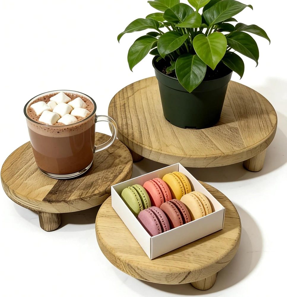 Three round natural wood pedestal risers in graduated heights