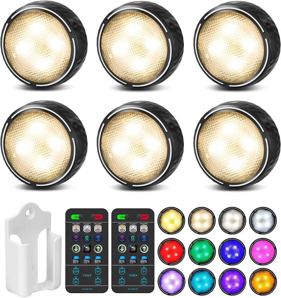 Six round black battery-operated LED puck lights with remotes