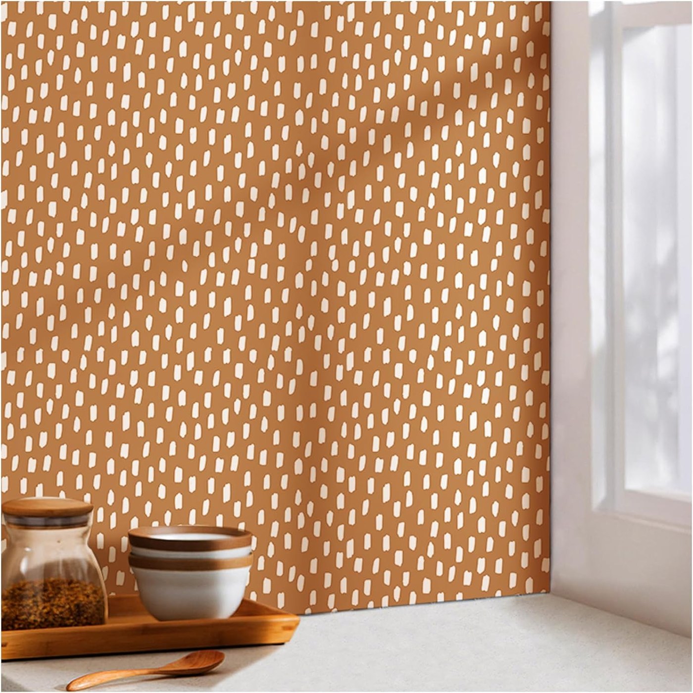 Roll of caramel peel-and-stick wallpaper with cream brushstroke pattern