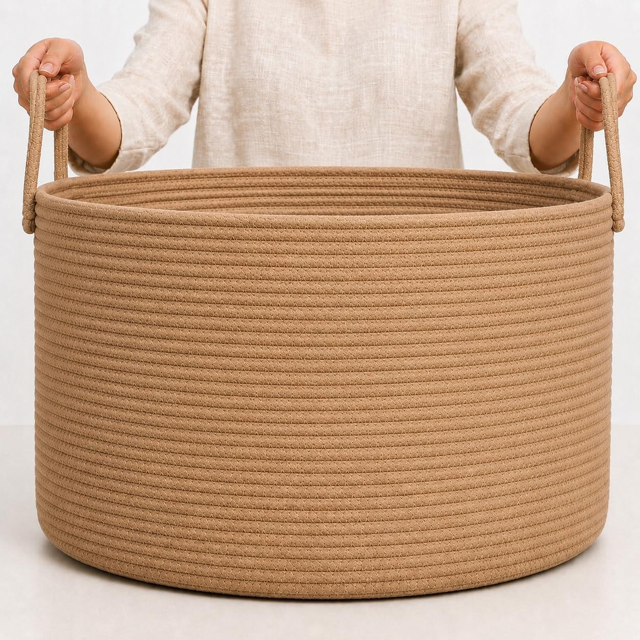 Wide round honey-toned cotton rope basket with handles