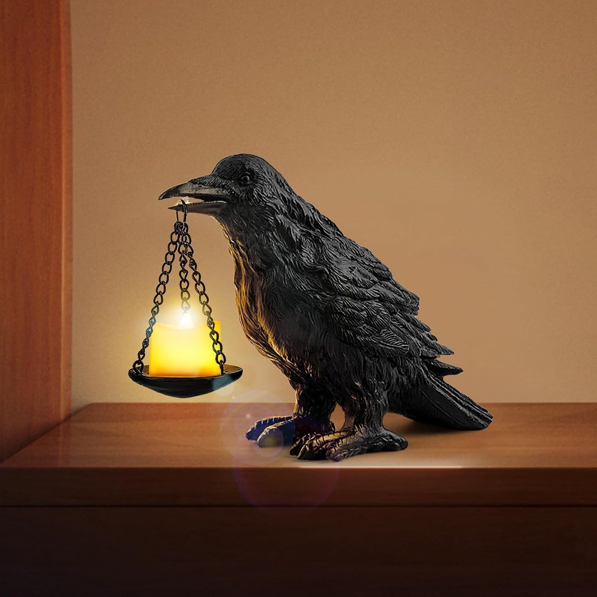 Matte black resin raven holding a small suspended pan sized for a single tealight
